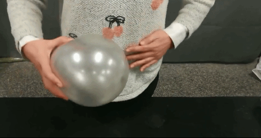 在毛衣上摩擦摩擦然后拿着准备好的气球和塑料绳环粘出来的圆环不易